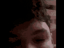 a close up of a person 's face with their eyes closed .