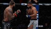 a man is laying on the ground in a boxing ring with a sign in the background that says ufc pass .