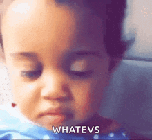 a close up of a baby 's face with the words whatevs written on the bottom