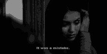 a black and white photo of a woman with the words " it was a mistake " below her
