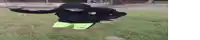 a person in a hoodie and green shorts is flying through the air .