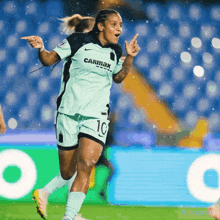 a female soccer player wearing a carmax jersey