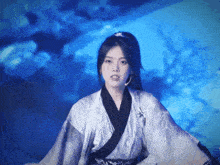 a woman in a kimono is standing in front of a blue sky