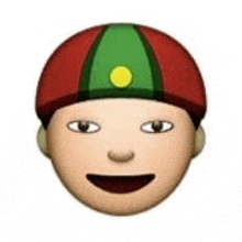 a boy wearing a red , green , and yellow hat with a yellow circle on it .