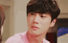 a close up of a person 's face with a pink shirt that says favoriteblue on it
