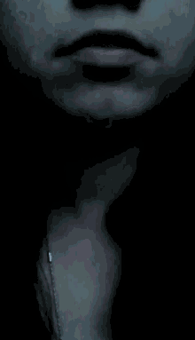 a close up of a person 's face with a necklace around their neck