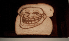 a troll face is drawn on a piece of bread