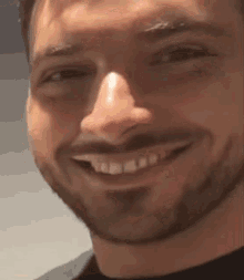 a man with a beard looks at the camera
