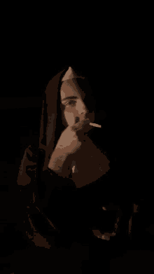 a man dressed as a nun smoking a cigarette