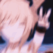 a blurry picture of a girl giving a peace sign