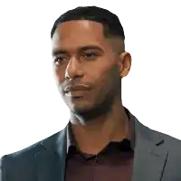 a man wearing a suit and a maroon shirt is looking at the camera