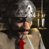 a man wearing a helmet and a red tie is smoking a pipe .
