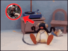a cartoon penguin wearing headphones is sitting in front of a record player