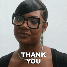a woman wearing glasses says thank you