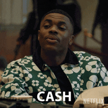 a man wearing a green and white jacket with the word cash on it