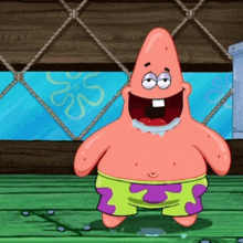 patrick star from spongebob squarepants is standing on a wooden floor