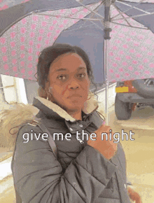 a woman is holding an umbrella and says give me the night .