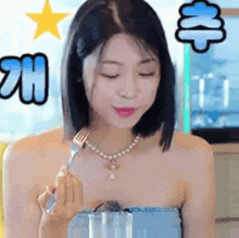 a woman is holding a fork over a glass of water and eating something .