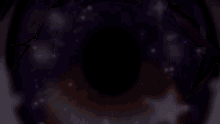 a close up of a person 's eye with a galaxy in the background