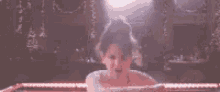 a woman is taking a bath in a bathtub with bubbles coming out of it .