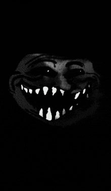 a black and white drawing of a troll face with a large smile .