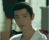 a close up of a man 's face with a bun on his head