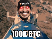 a man wearing a bitcoin hat is smiling and riding a sled