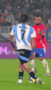 a soccer player wearing a number 7 jersey kicks a ball