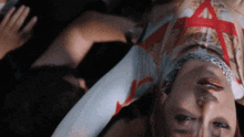 a woman is laying upside down with a red star on her shirt