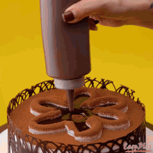 a cake being decorated with chocolate and the words easy plus on the bottom