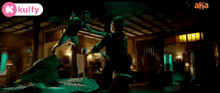 a woman in a green dress is dancing in a dark room with lights on .