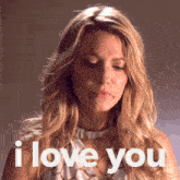 a woman says " i love you " in white letters