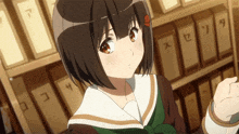 a girl in a school uniform is standing in front of a shelf with boxes on it with chinese characters on them