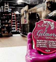 a purple chair with a red sign that says gilmore