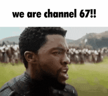 a man with a beard is standing in front of a crowd of people and says we are channel 67 .