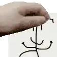 a person 's hand is holding a piece of paper with a drawing on it .