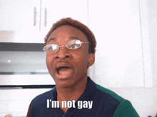a man wearing glasses and a blue shirt says i 'm not gay