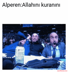 a group of men sitting in front of a crowd with the caption alperen allahini kuranini