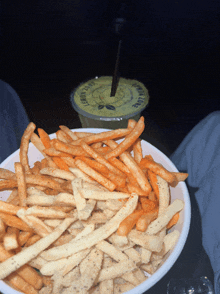 a bowl of french fries next to a drink that says lemon cafe