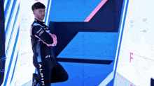 a man in a black and pink suit with the word alpin on the side