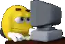 a yellow smiley face is sitting in front of a computer monitor .