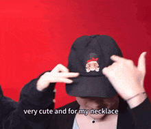a woman is wearing a black hat and necklace and says very cute and for my necklace