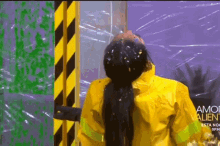 a woman in a yellow raincoat is covered in food