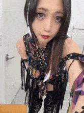a woman taking a picture of herself with a purple eye