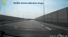 a car is driving down a highway with the date of july 22