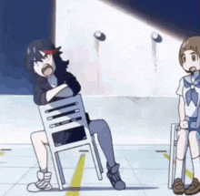 a girl is sitting on a chair while another girl sits on a chair