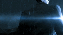 a man holding a gun in a dark room