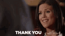 a woman is smiling and saying `` thank you '' in a hallmark movie .