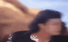 a blurry picture of a woman 's face with the words `` in '' written on the bottom .