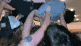 a person wearing a blue shirt that says ' nebraska ' on the front